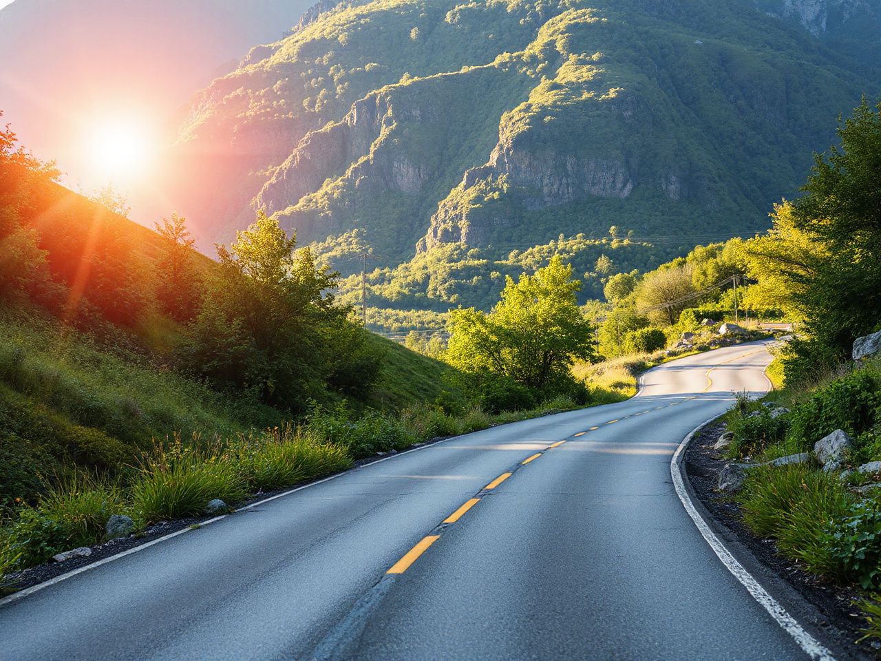 A sunlit mountain road winding through lush greenery, perfect for showcasing unisex bicycle frame versatility