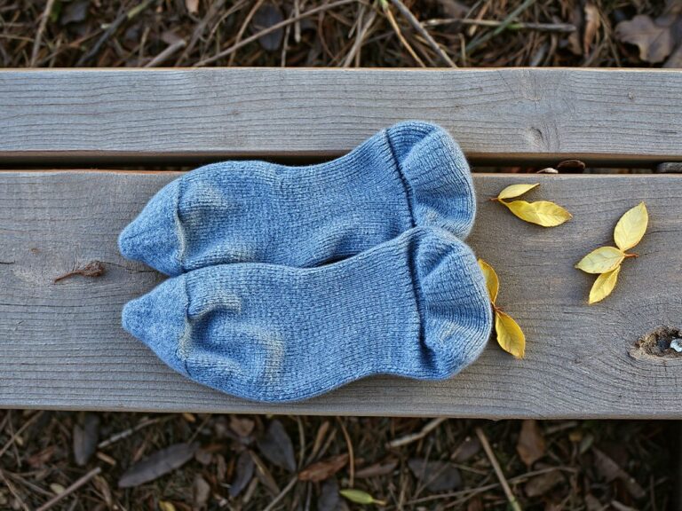 Pair of grey wool hiking socks on a trail bench