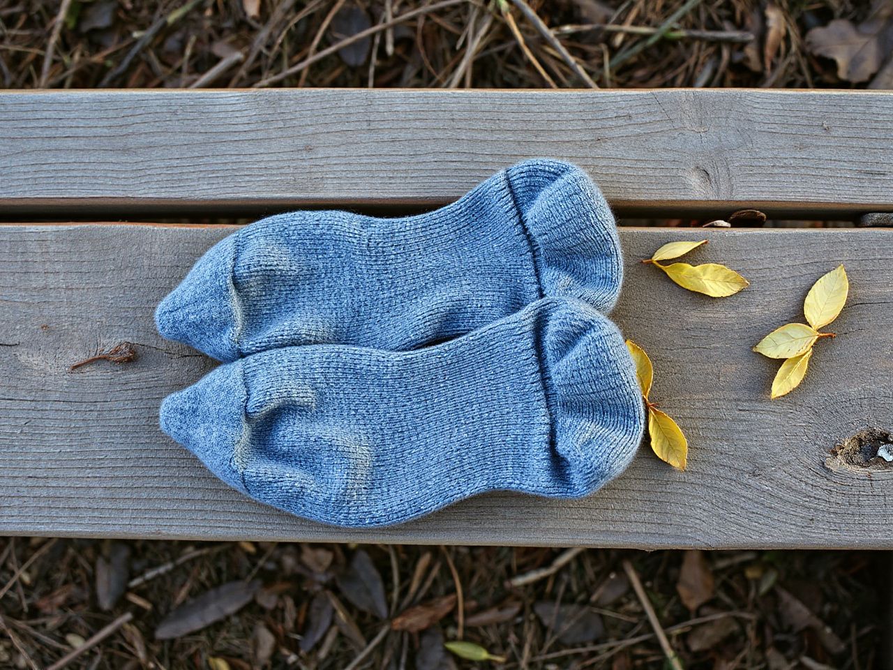 Pair of grey wool hiking socks on a trail bench